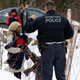 Police talking to a woman who said she and her family were from Sudan, Feb. 12. (Reuters/Christinne Muschi)